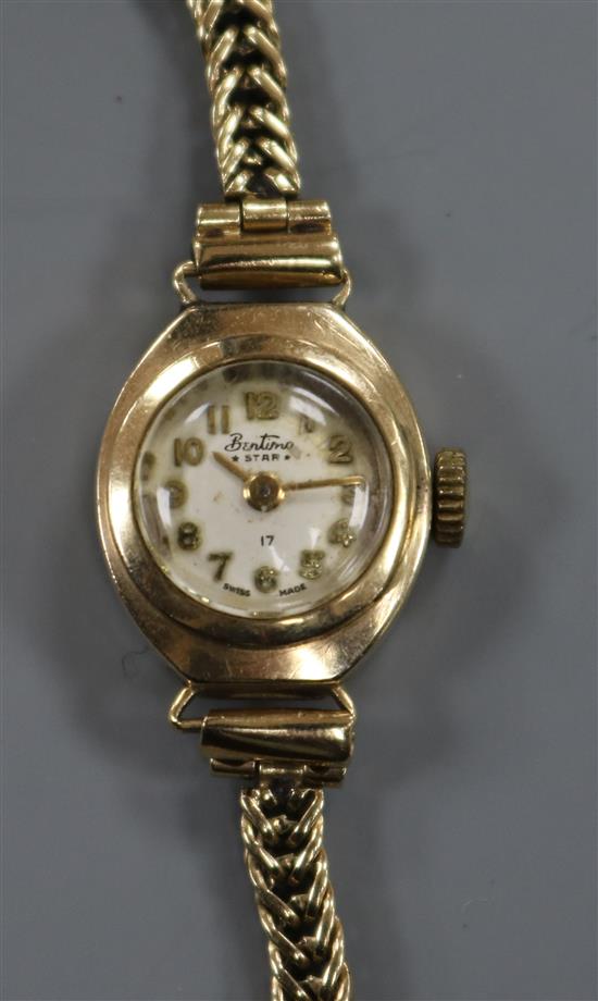 A ladys 9ct gold Bentimo manual wind wrist watch on a 9ct gold bracelet.